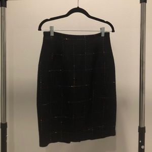 Multicolored yarn pattern on black mini skirt.